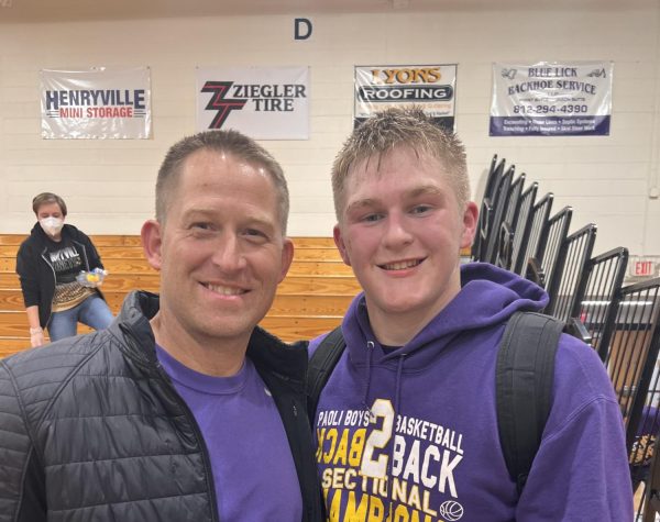 Senior Andrew Kumpf and his dad. Tyler Kumpf, taking a picture together.