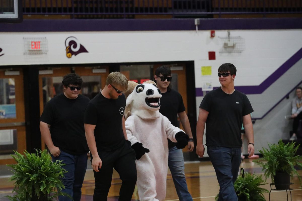 Rocky the Ram gets escorted out by her security guards.
