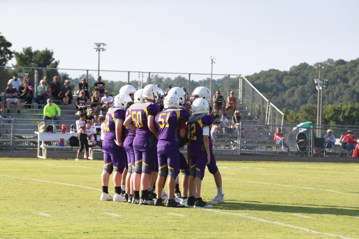 Junior high team huddles before starting the next play. 