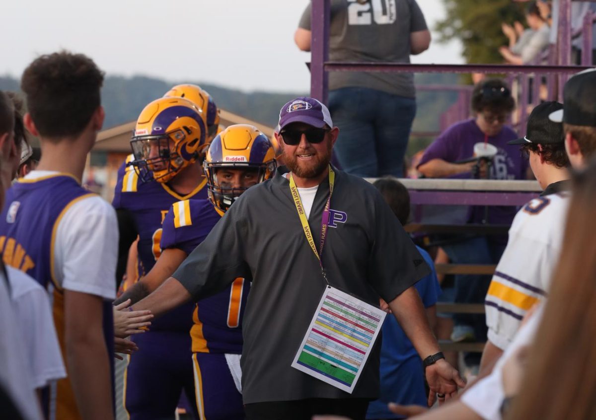 Head Coach Neil Dittmer walks through the student tunnel before the game.