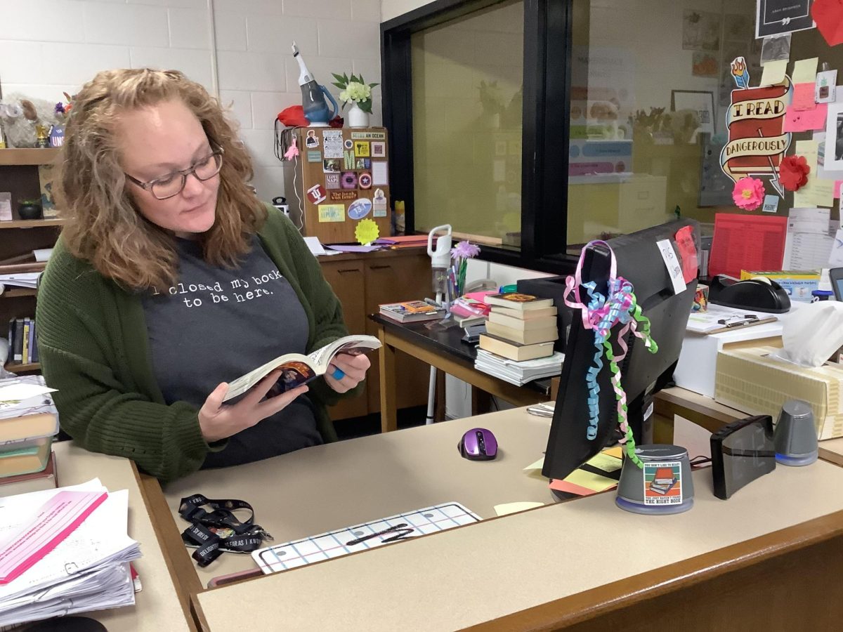 Miller reading a book in the library