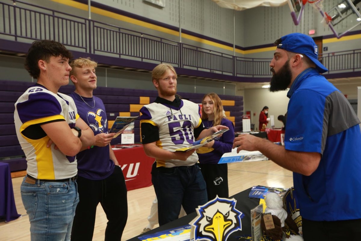 Seniors Coy Busick, Fletcher Cole, and Jackson Reynolds, listens to college representative. 
