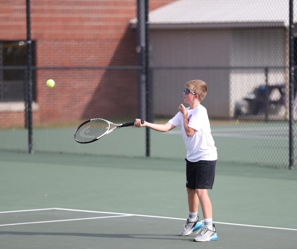 Seventh Grader Harper Thacker swings to hit the ball. 