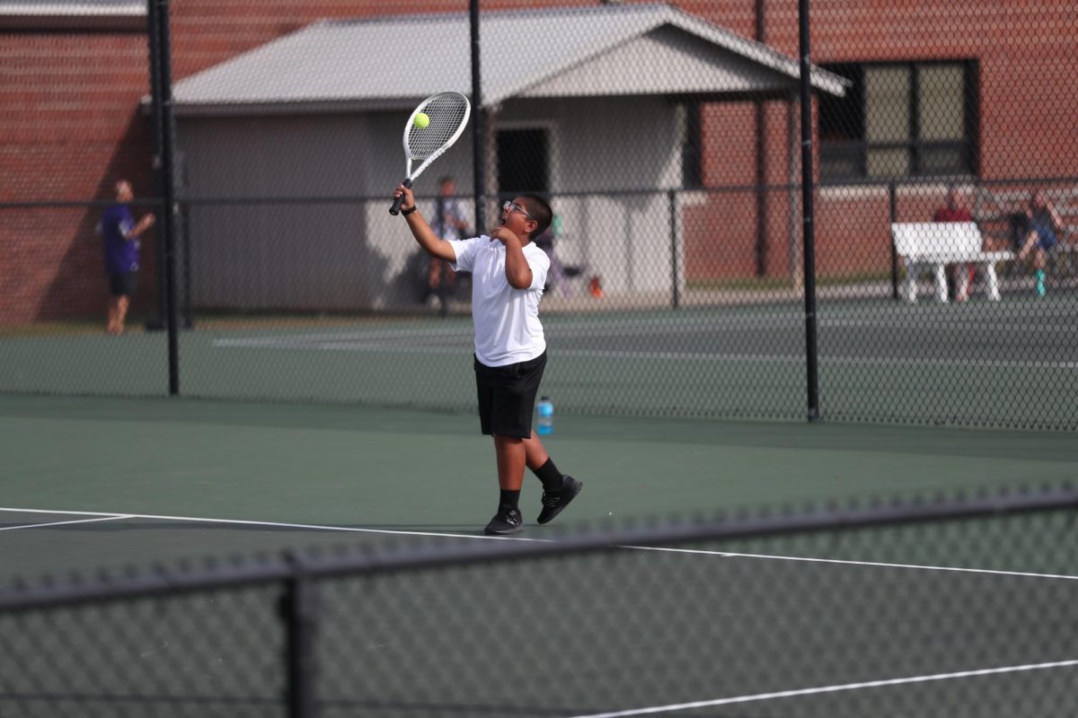 Sixth Grader Jacob Zapien serves the ball over. 