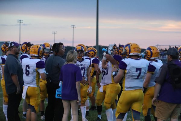 Team huddles with defensive coach Aaron Hannon during timeout. 
