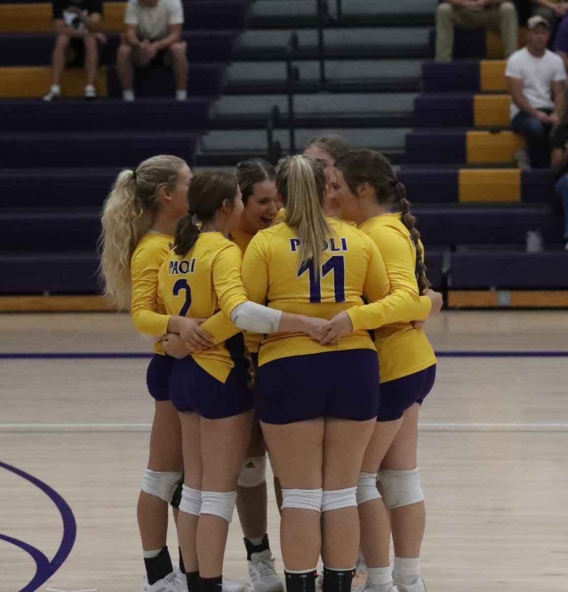 Varsity starters huddle before the start of the game. 
