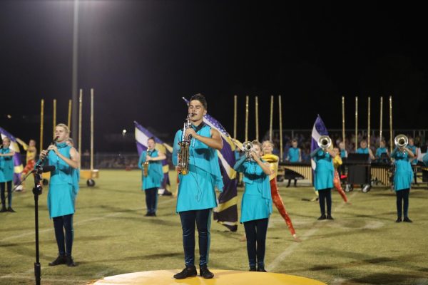 Senior Christian Longest plays his saxophone along with the band.