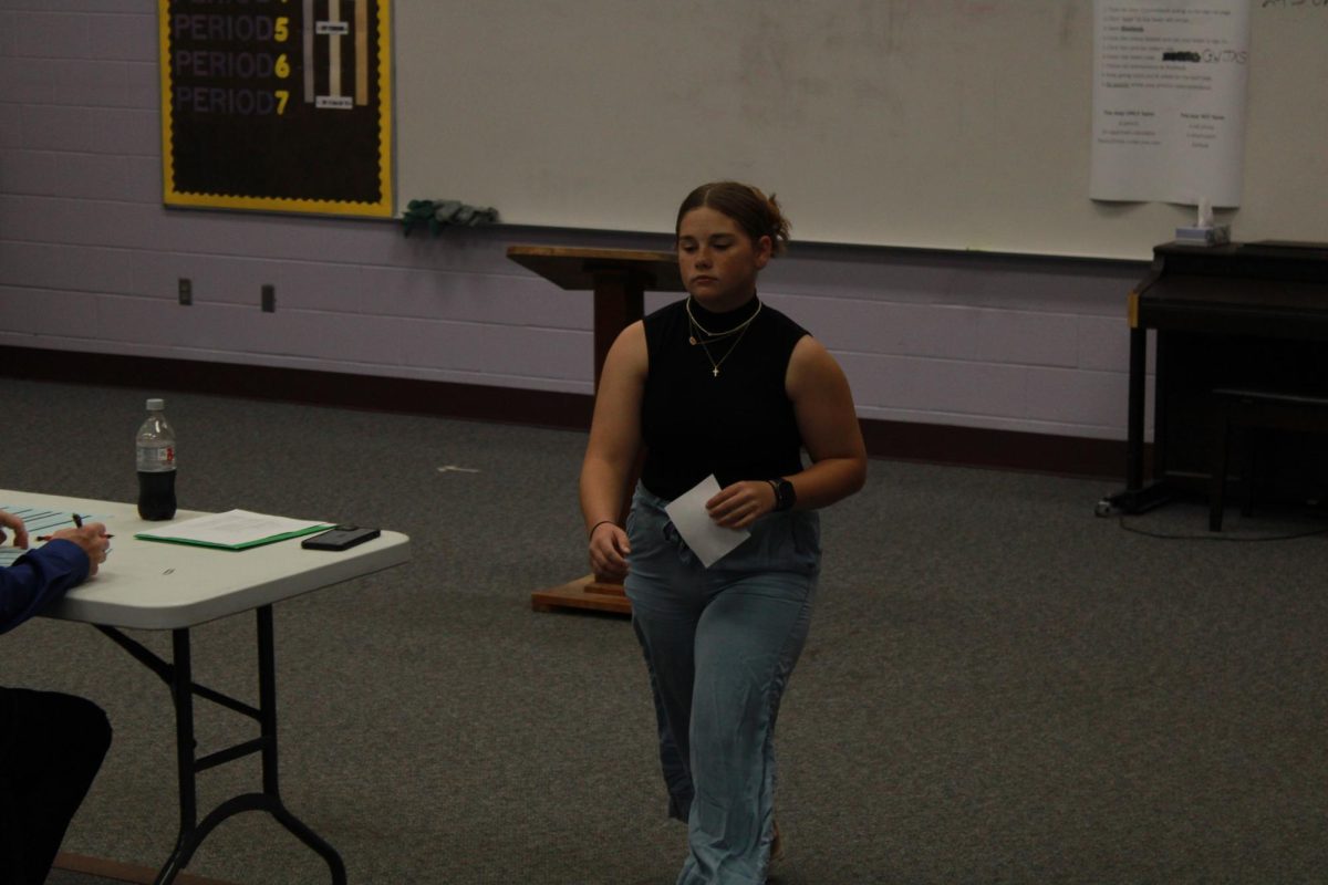  Freshman Vanessa Thacker walking back to her seat after reading her contemporary poem.

