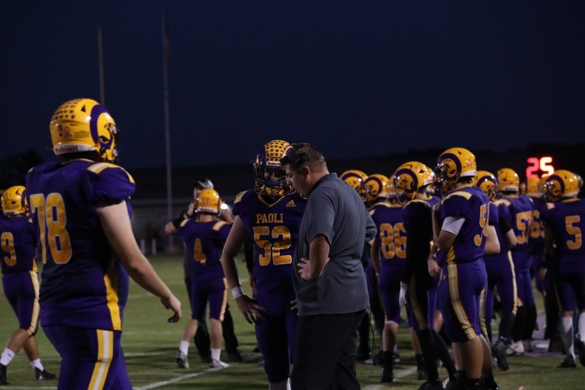 Senior Jaxson Reynolds talks strategy with Coach Garrett Sanders.