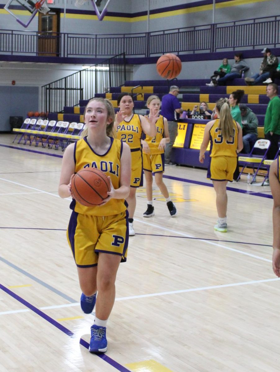 Eighth Grader Jenna Livingston warms up with layups.