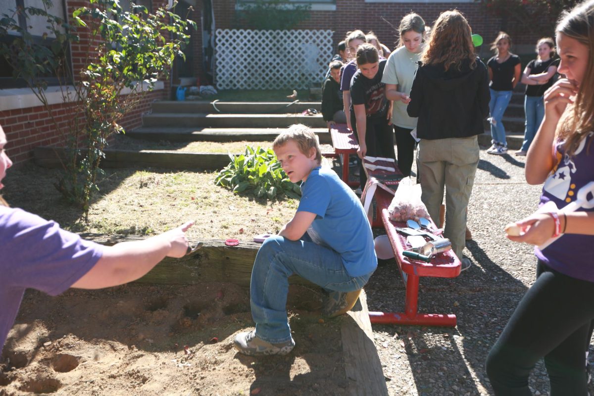 Sixth grader Easton Arsenault works in the garden for Red Ribbon Week in the Throop courtyard