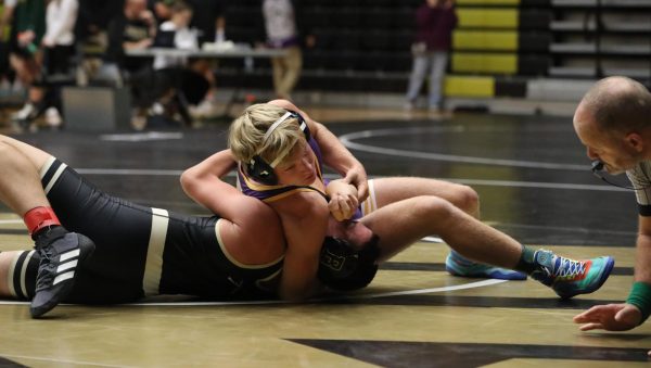 Senior Jonny Shellenburger pins his opponent.