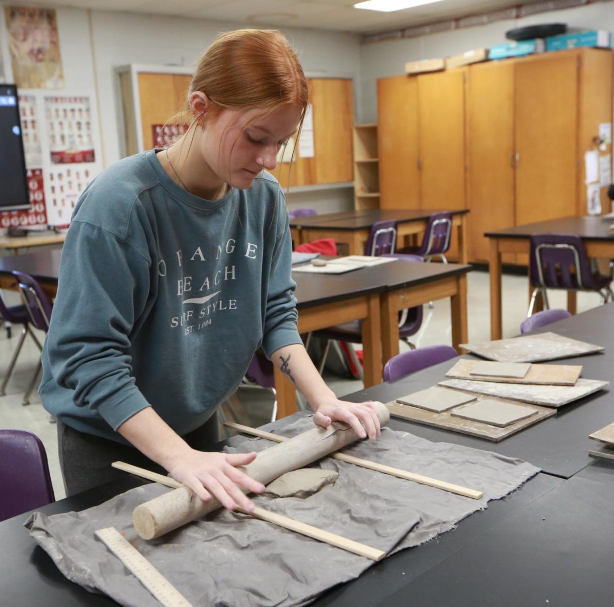 Junior Ava Hall rolls her clay out flat.