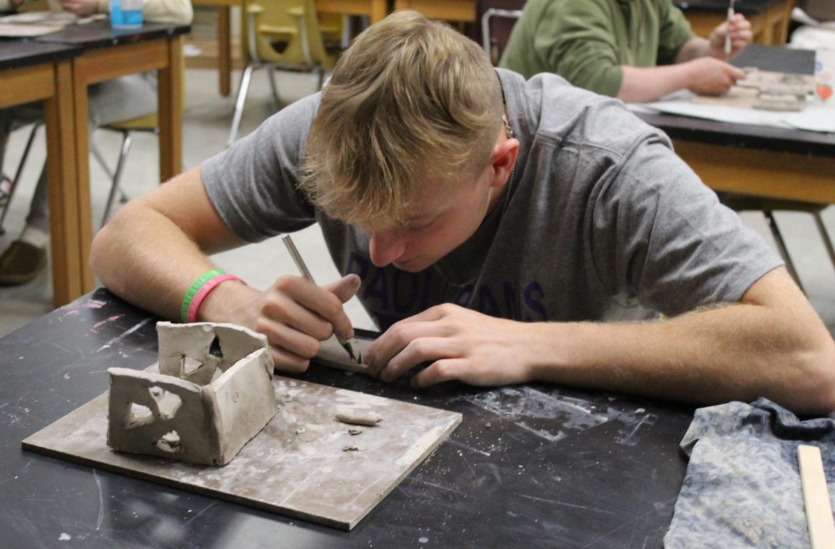 Senior Fletcher Cole shapes his last side to his project.