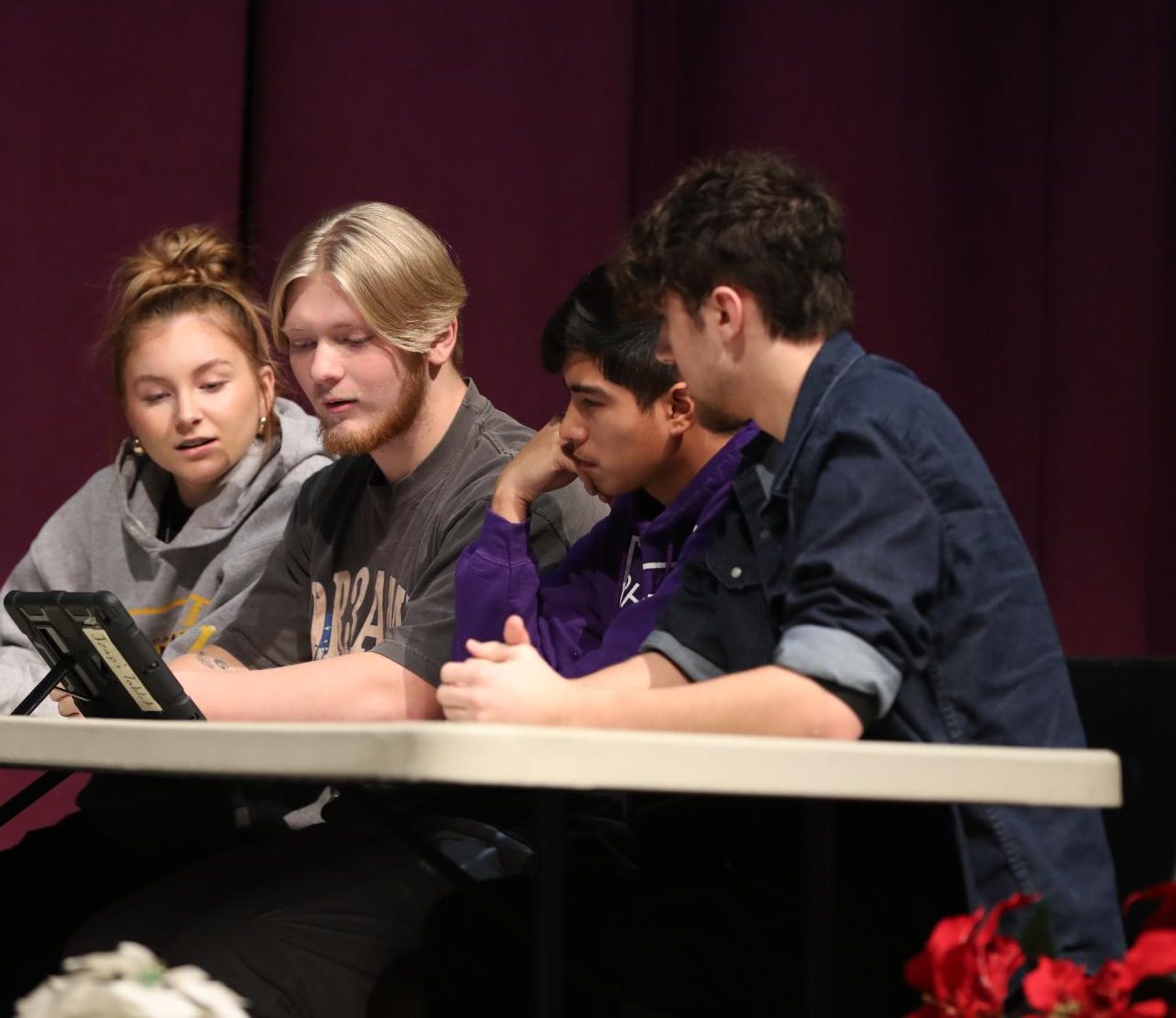 Seniors Taylor Patton, Coy Busick, Josh Zapien, and Odin Gehl looking at their Chromebook to decide on an answer.