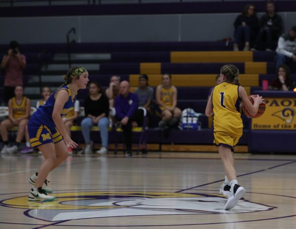 Seventh Grader Emma Bradley brings the ball down the court.