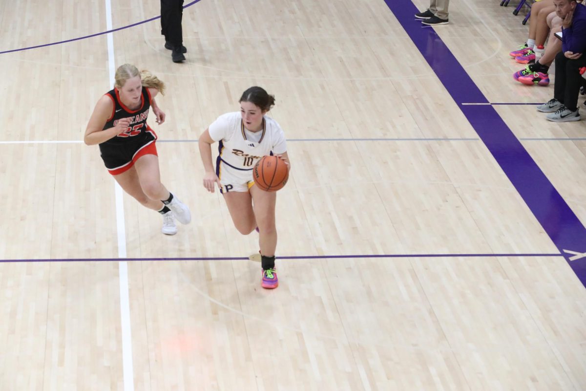 Senior Avery Crews brings the ball down the court against an Orleans opponent. 