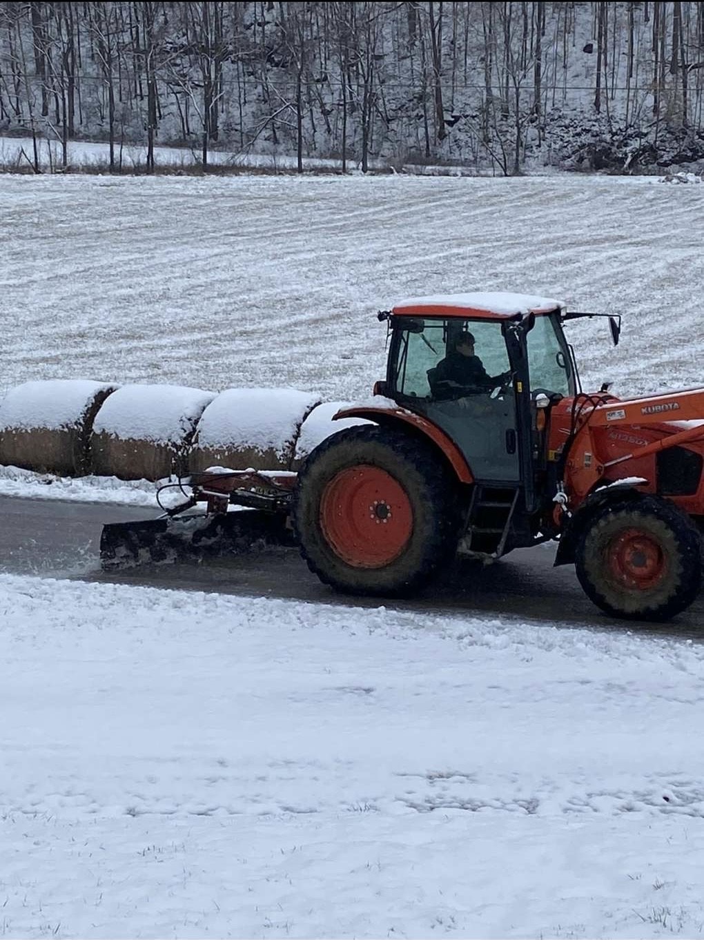 Drake operating his tractor in the snow