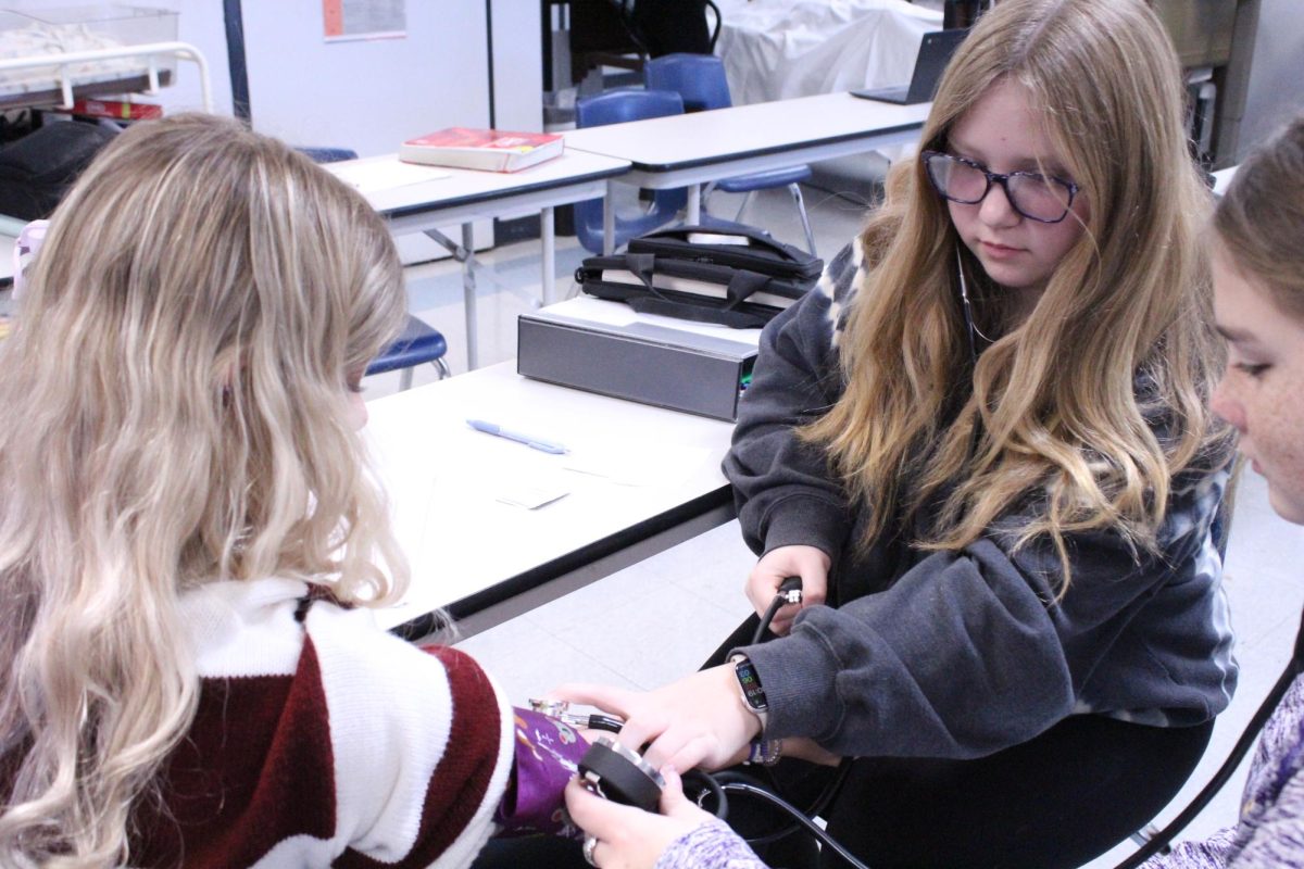 Freshman Shelby Walls takes blood pressure.