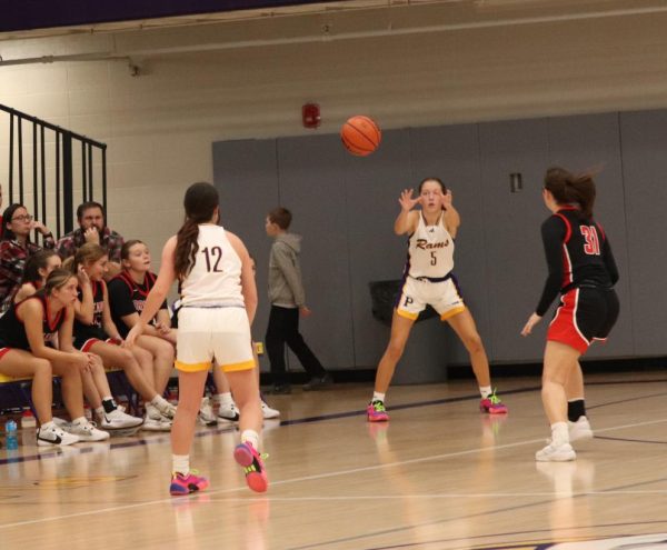 Senior Lilly Hall passes the ball the Sophomore Addie Payton.