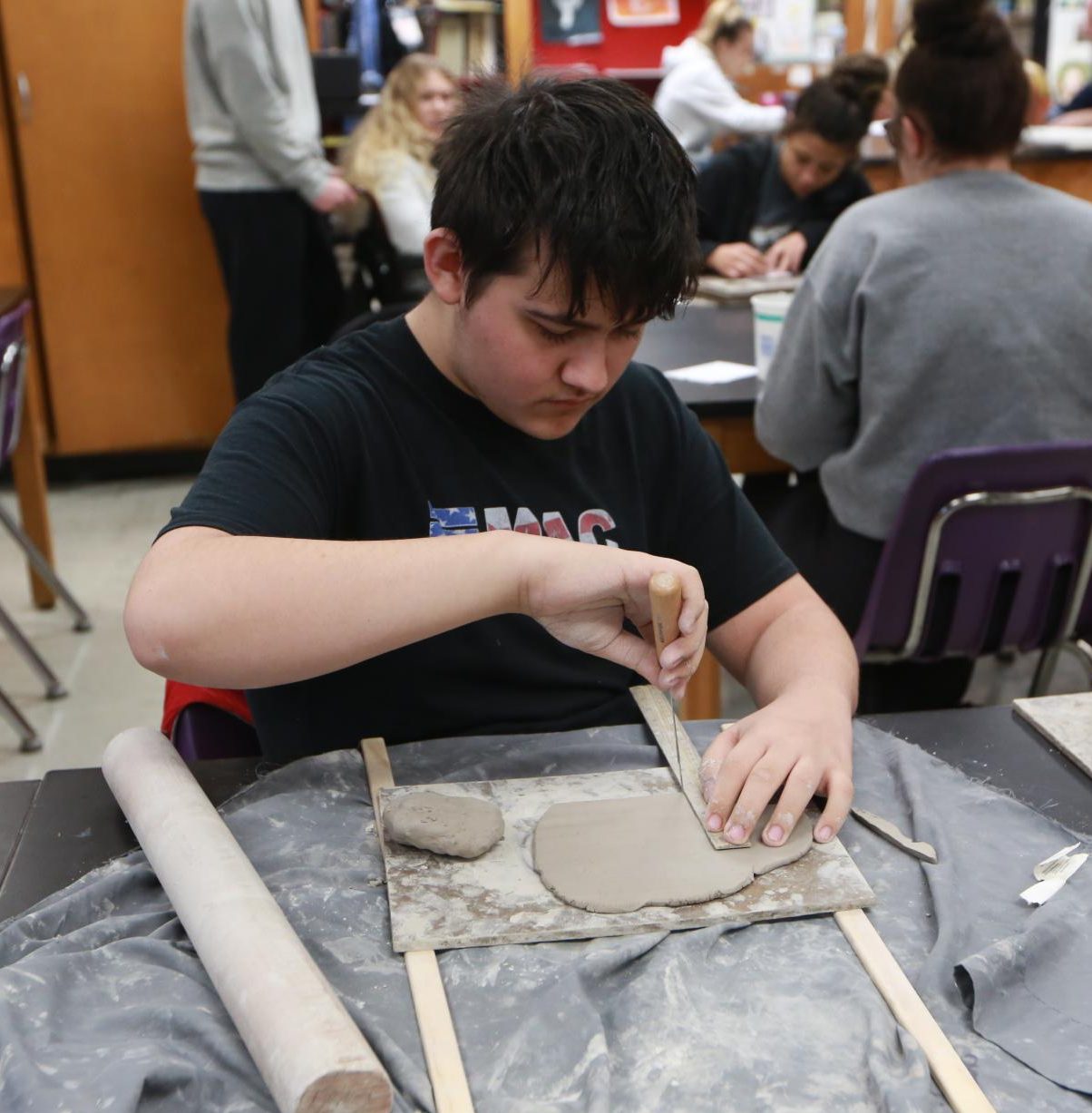 Sophomore Todd Chastain cuts his clay