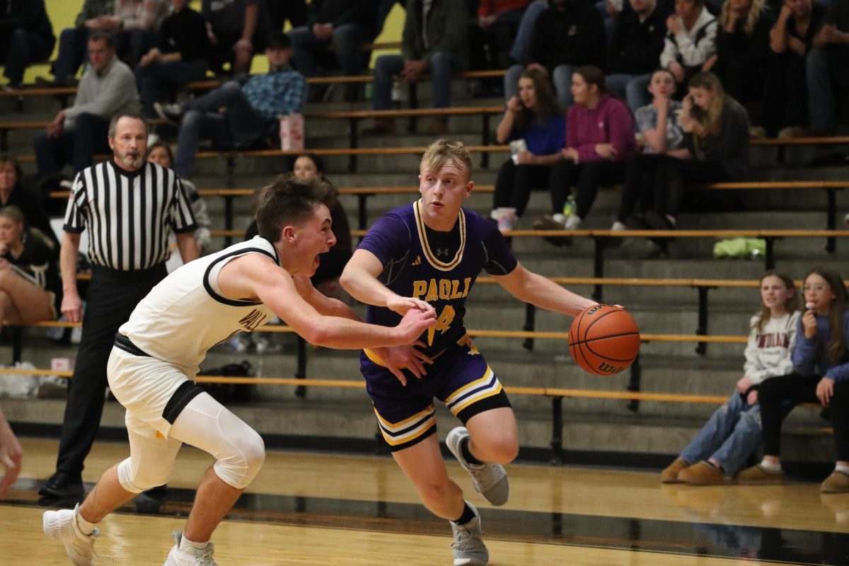 Senior Fletcher Cole drives against a Springs Valley player in the January 24 game. 