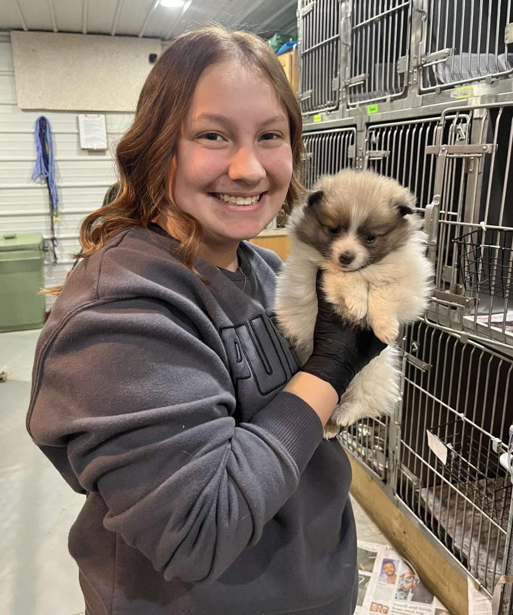 Senior Chloe Smith poses with an animal at the clinic. 