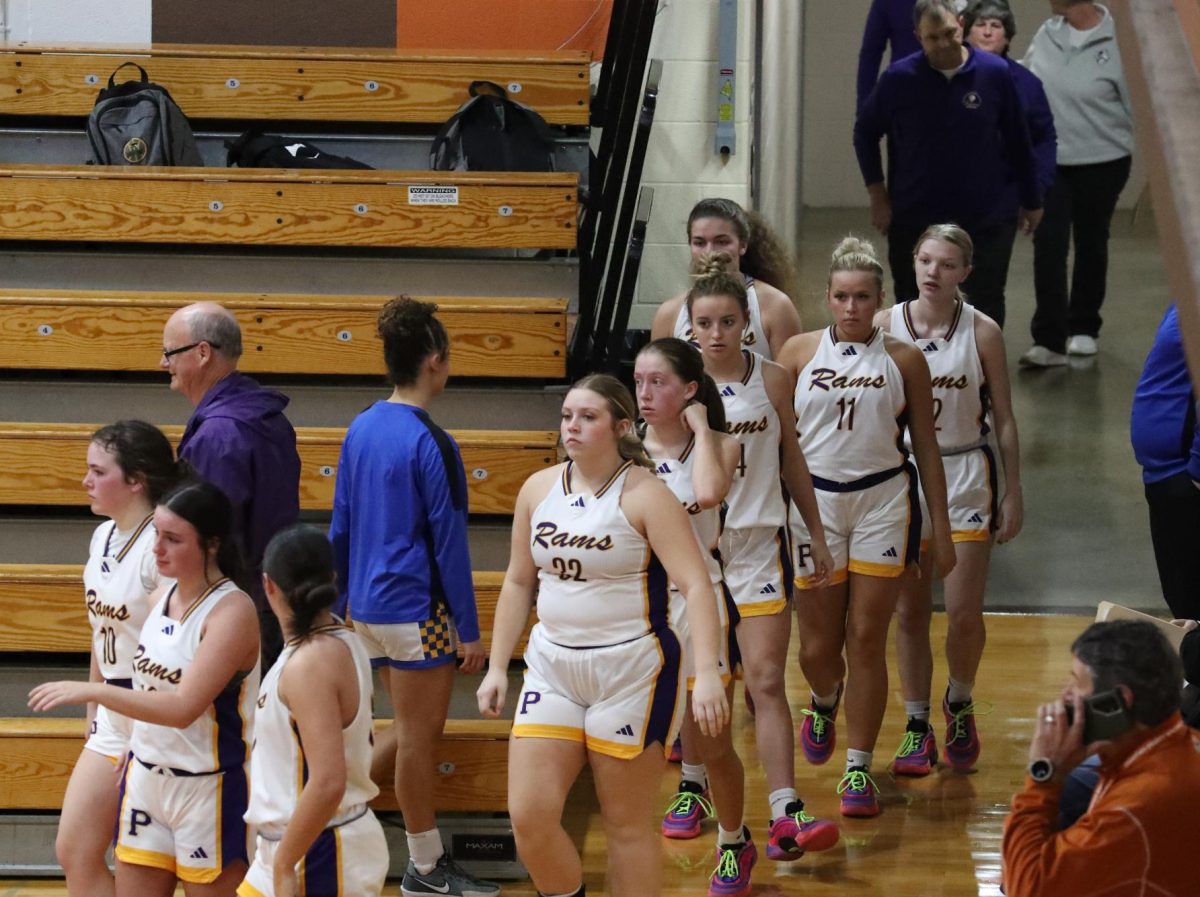 The girls basketball team walks out of the locker room ready to play.