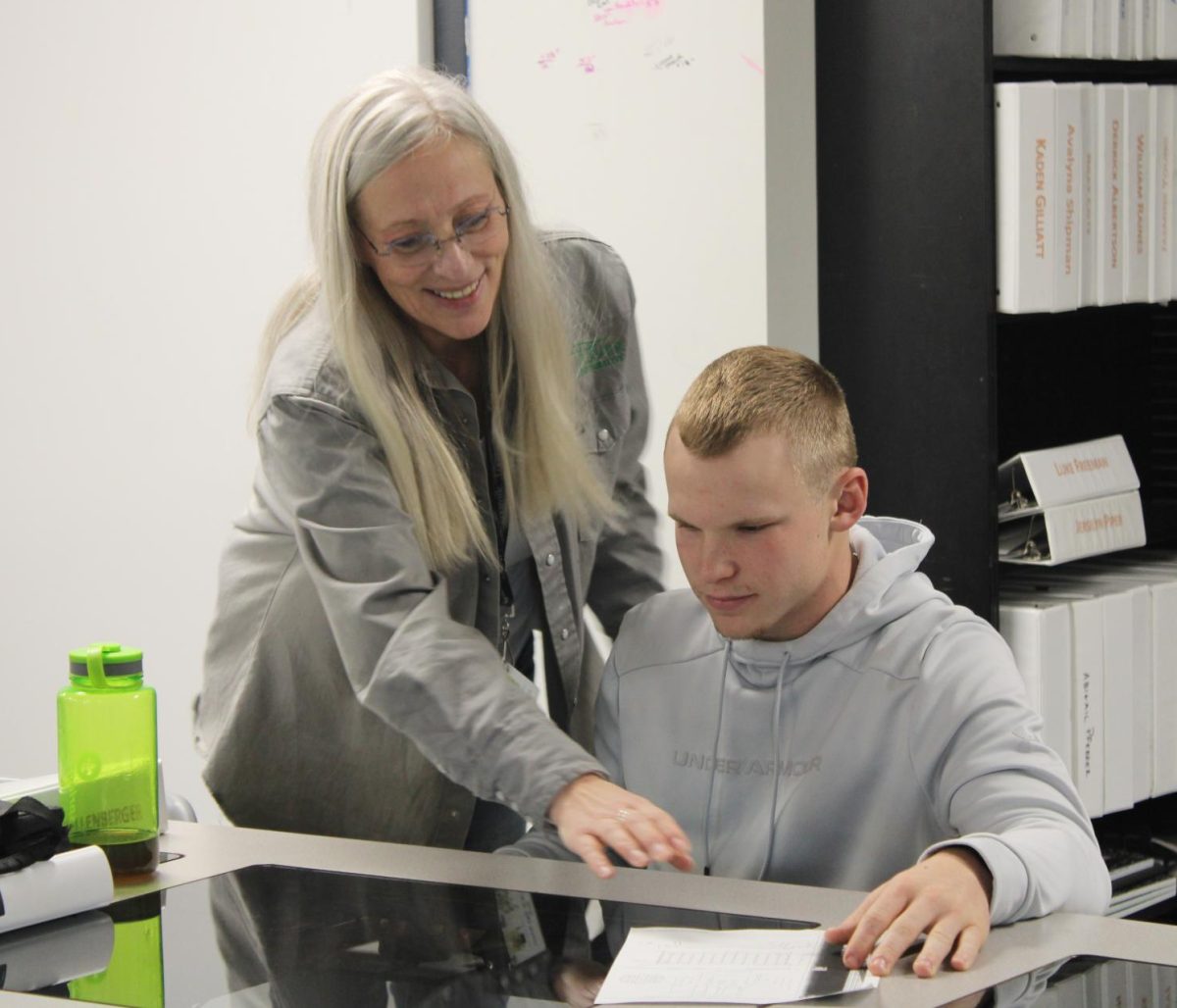 Engineering teacher Cis Zehr showing senior Jonny Shellenberger about the computers.