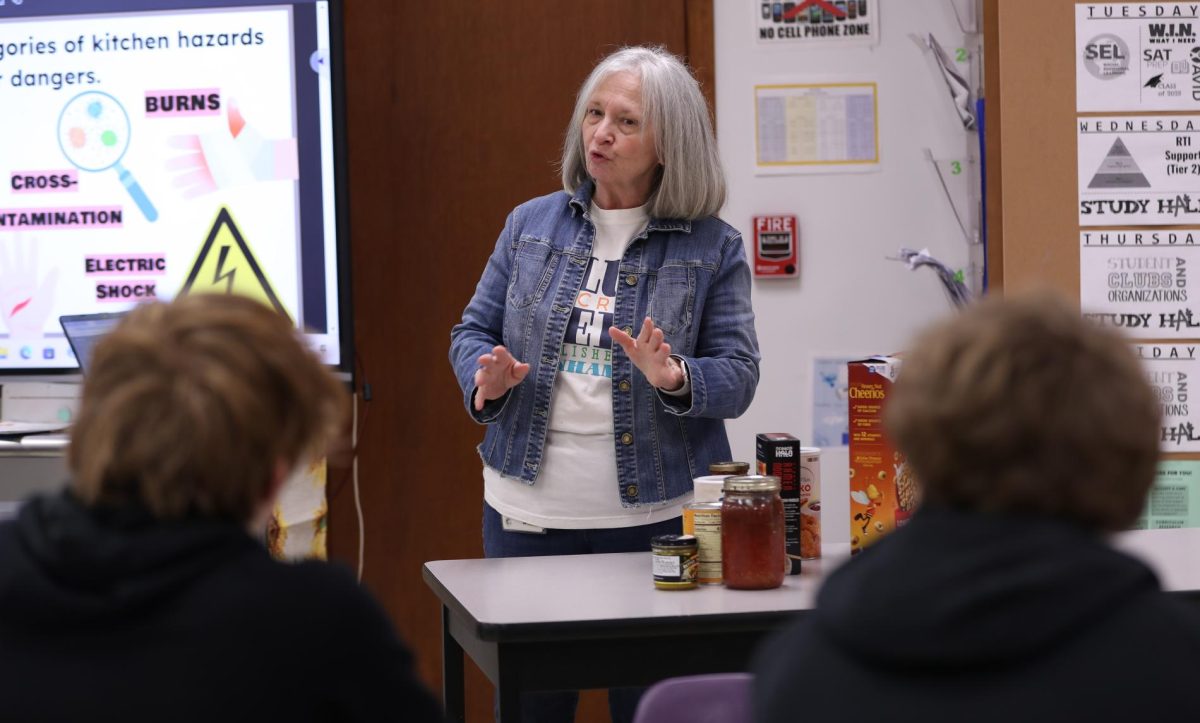 Cooking teacher Debbie Andry teaches students about proper food storage.