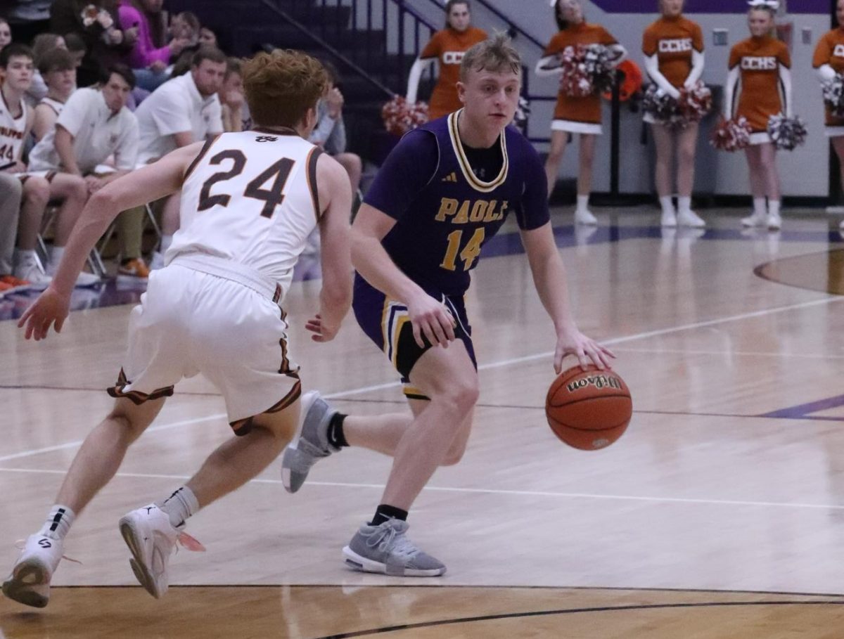 Senior Fletcher Cole keeps ball away from opponent.