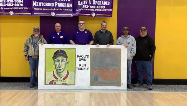 PHS was presented with the Ken Trinkle mural to be displayed at the Trinkle Field dugout. Presenting the mural from left are Town Board President Bobbie Bostock, Principal Ed Wagner, Athletic Director Darek Newkirk, Superintendent Greg Walker, Town Board Member Theron Owens, and Park Director David Grimes.