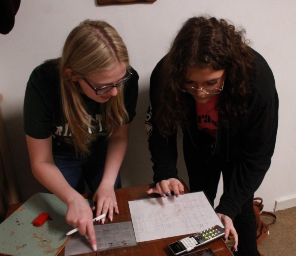 Senior Paige Flick and Junior Sirinity Anderson work together to find clues.