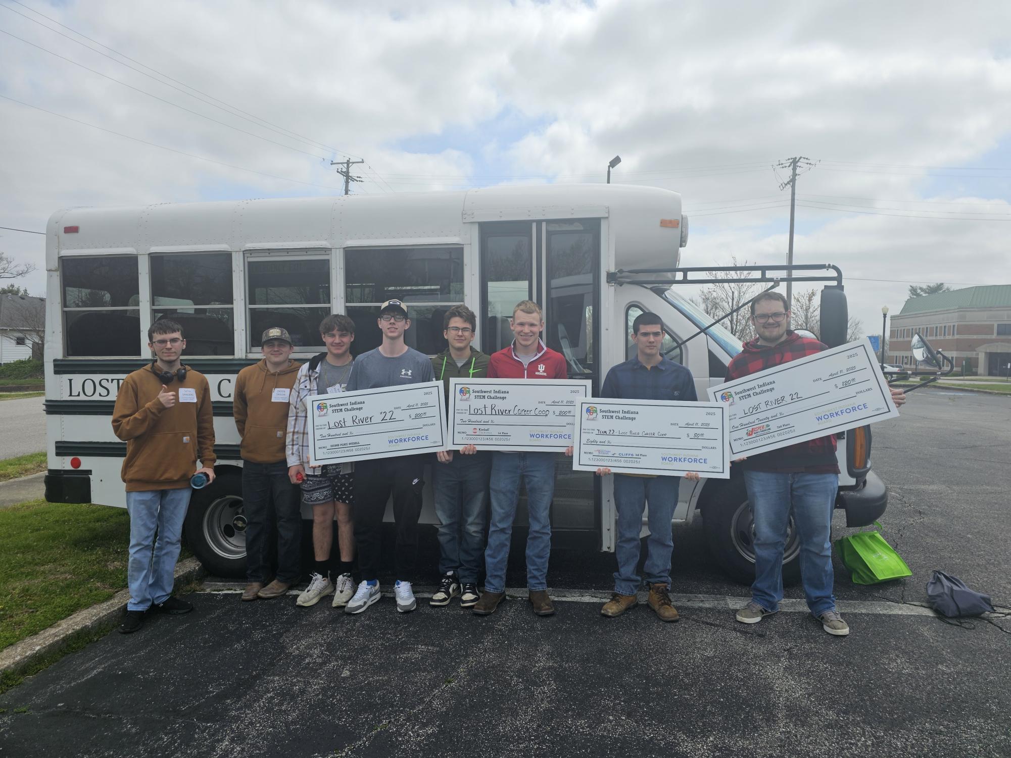 The Indiana STEM Challenge winners pose with their checks. Pictured from left: Seth Sanders, Zaden Taylor, Wylee Ruckman, Josh Herd, Carson Neal, Jonny Shellenberger, Mathew Tedrow and Oscar Lewellyn. 