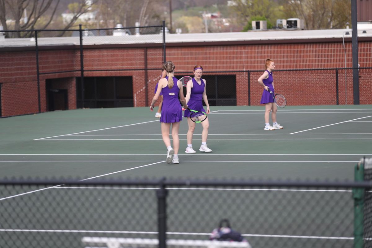 Junior Aurora Hays and Junior Audrey Hall cheer on each other during a game.