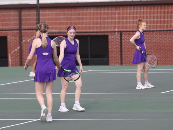 Junior Aurora Hays and Junior Audrey Hall cheer on each other during a game.