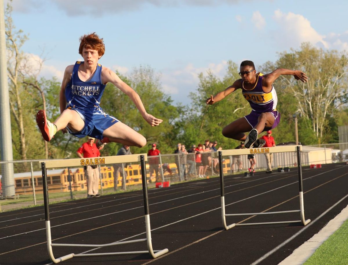 Freshman Moise hall jumps over the hurdle.