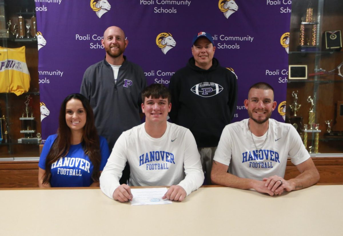 Baker is pictured with his mom Liana, dad Branden, Head Coach Neil Dittmer, and Offensive Line Coach Jeremy Reynolds. 