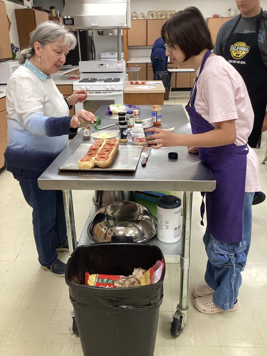 Debbie Andry works with Tori Rodriguez on a cooking lab. 
