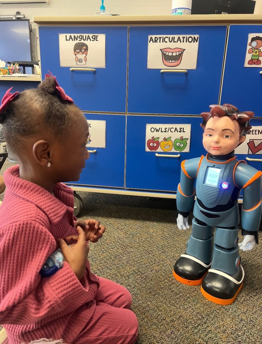 A Throop student engages with the Robokind robot during class time. 