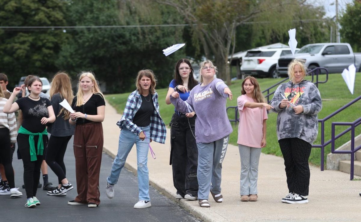 Students release their paper airplanes that they made.