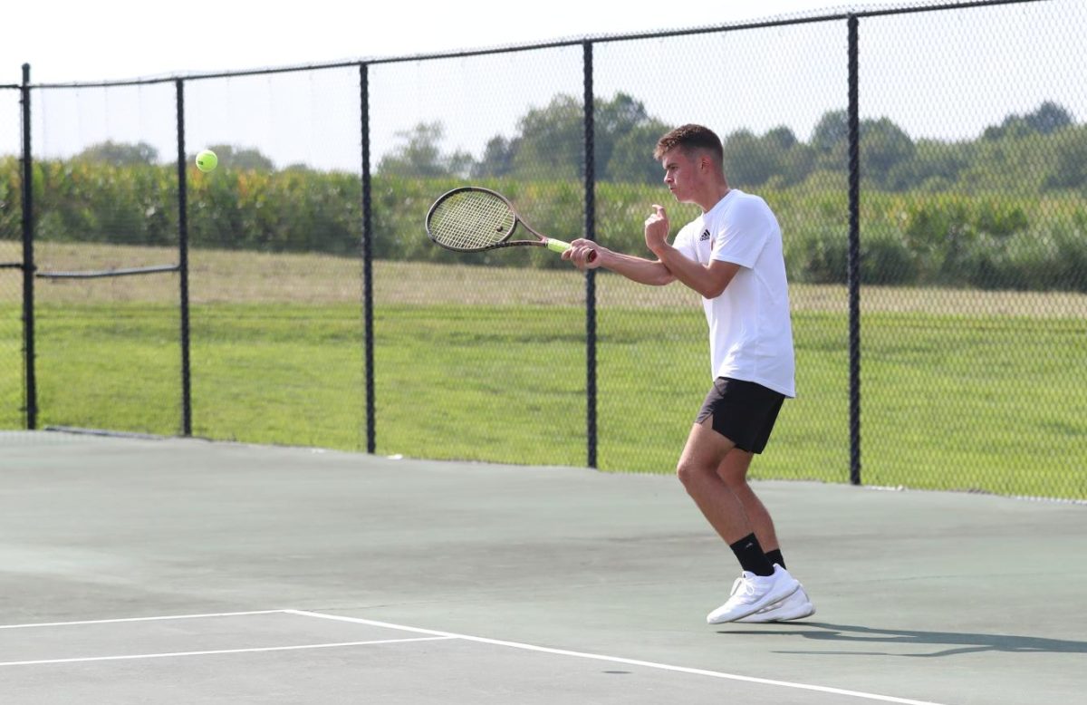 Junior Colton Henderson hits the ball. 
