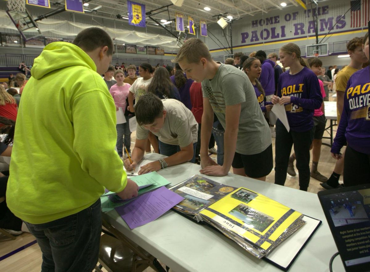 Students sign up for FFA at the display table.