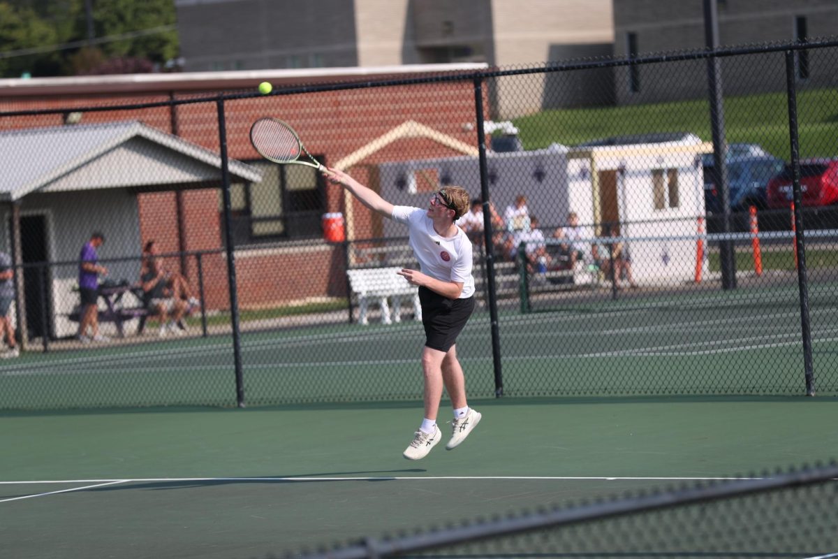 Senior Joshua Herd serves the ball to his opponent.