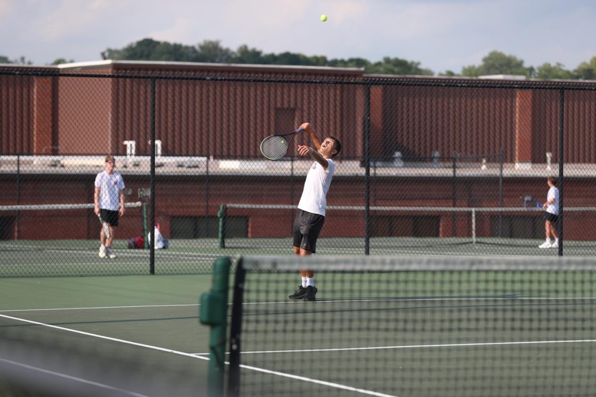 Junior Blaze Knapp serves the ball. 