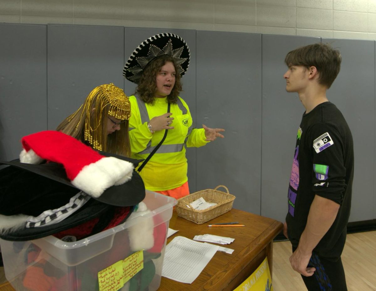 Drama students encourage kids to join at the display booth.