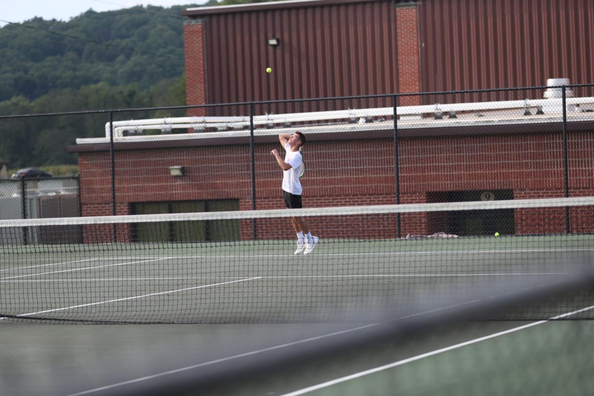 Junior Colton Henderson prepares to serve the ball. 