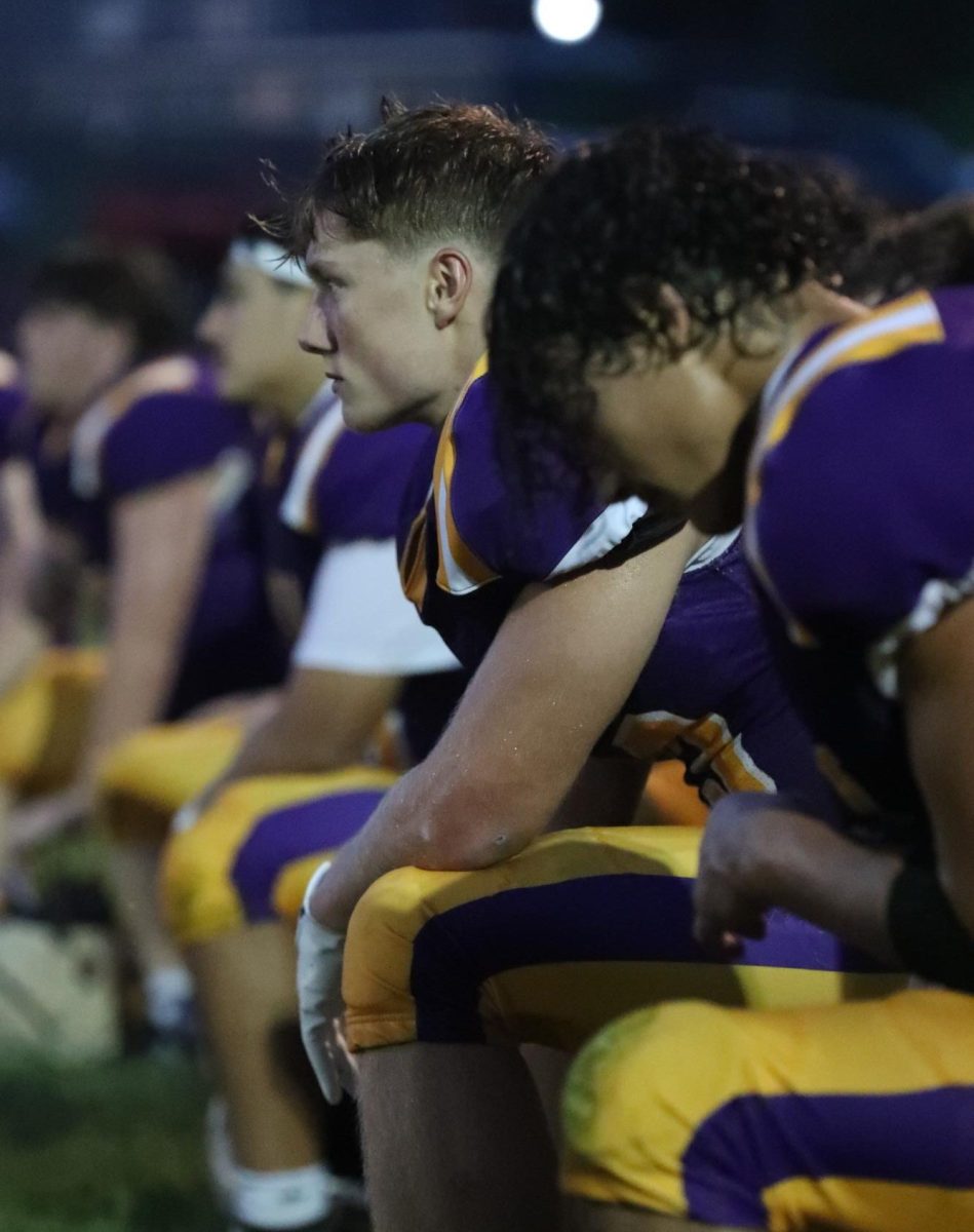 Senior Dane Padgett kneels with the Paoli Rams Football team.