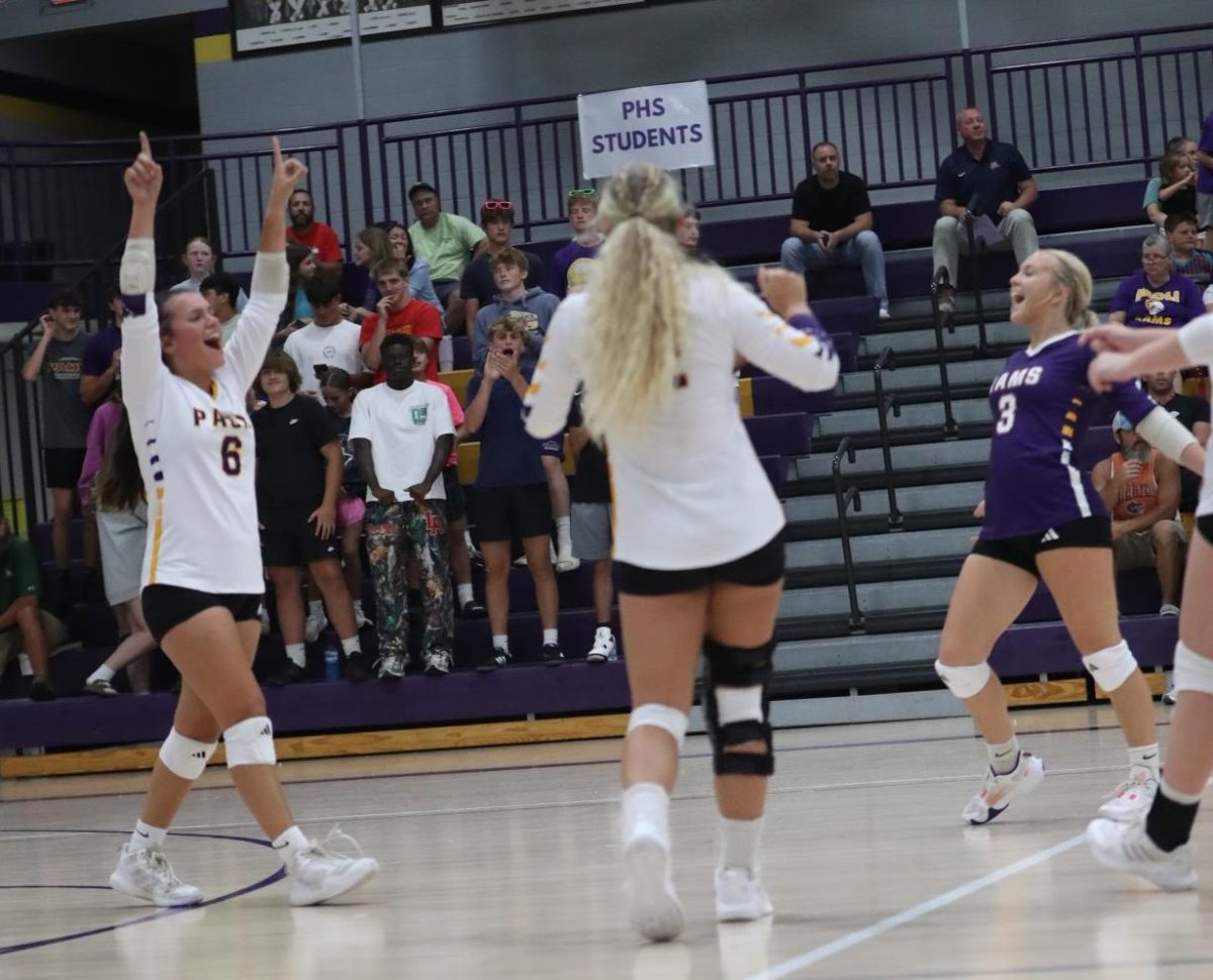 Sophomore Kalyn Hannon and Seniors Maddie Vernon and Tori Patton cheer after the point.
