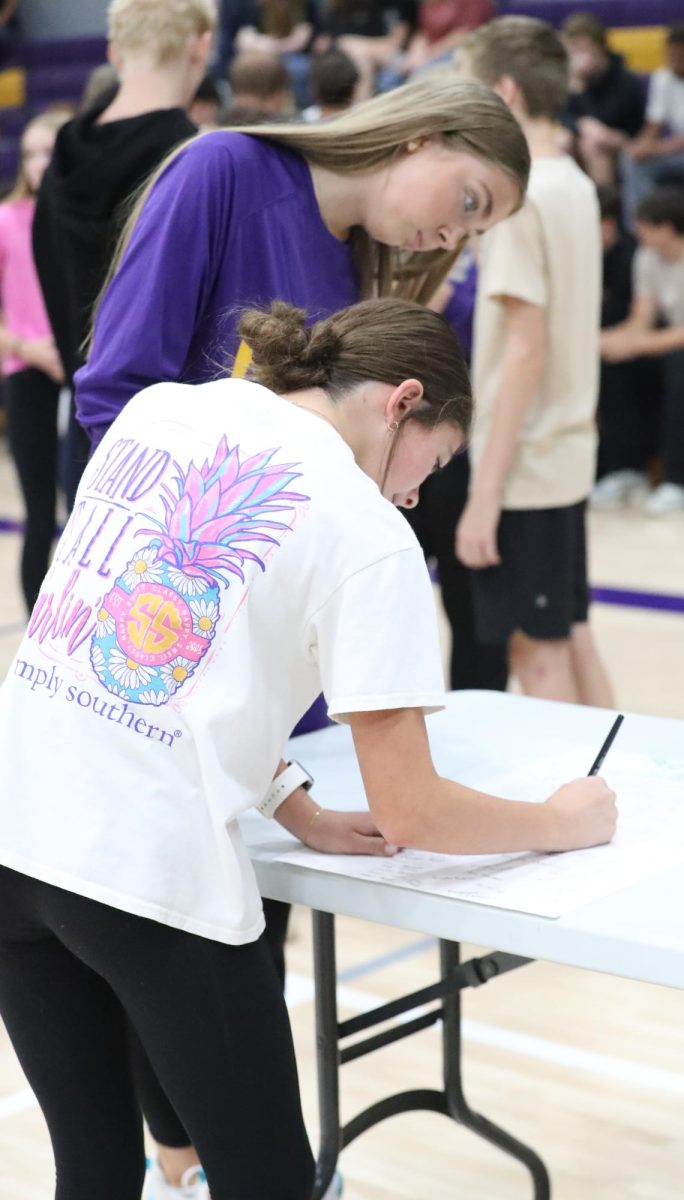 Chelsea Neukam and Macie McDonald sign up for a club at the fair.
